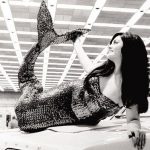 mermaid perched atop a 1967 Plymouth Barracuda.