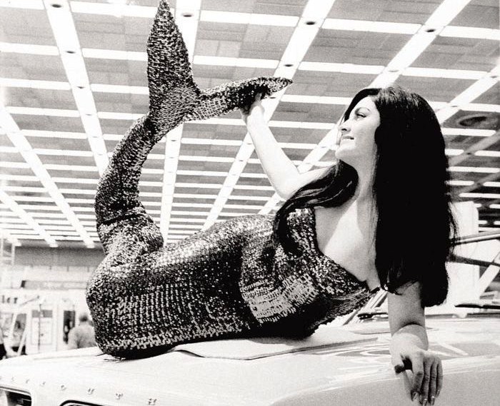  mermaid reclines on the hood of a new 1967 Plymouth Barracuda during an auto show. (Archive photo: AACA Museum)