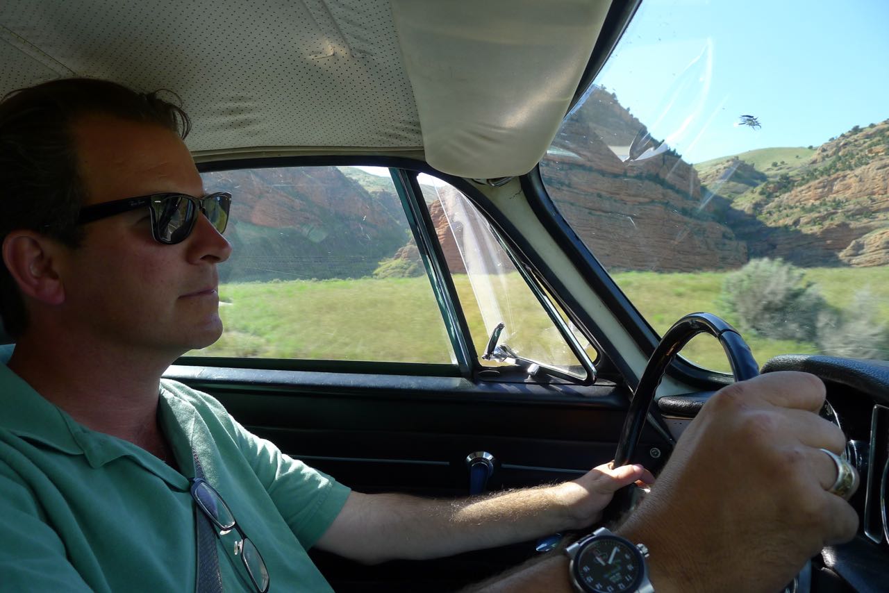 On the road in a vintage sports car