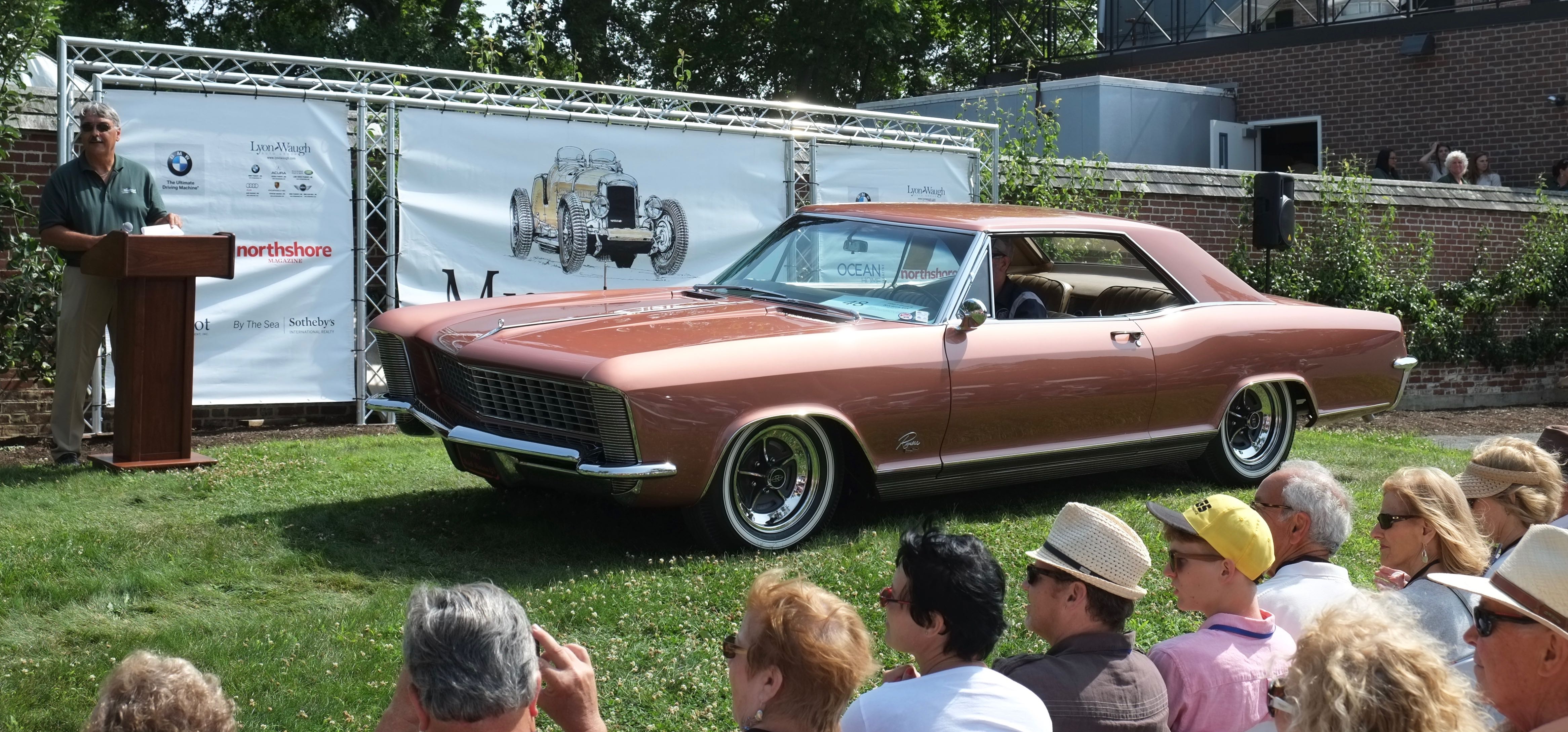 Beautifully restored 1964 Buick Riviera crosses the awards stand