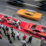 A cab speeds past the Ferrari display at the Hublot flagship store on Fifth Avenue