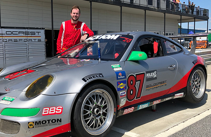 Lehman Keen poses with the 2009 Rolex GT Championship car. | Instagram photo/@lehmank