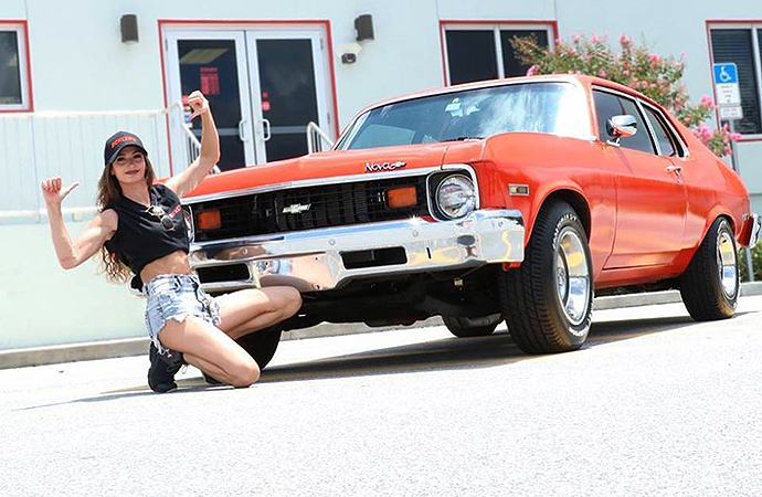 Amber Nova, an independent wrestler and organizer of a classic car show that combines professional wrestling and vintage vehicles, poses next to her restored 1973 Chevrolet Nova. | Facebook photo