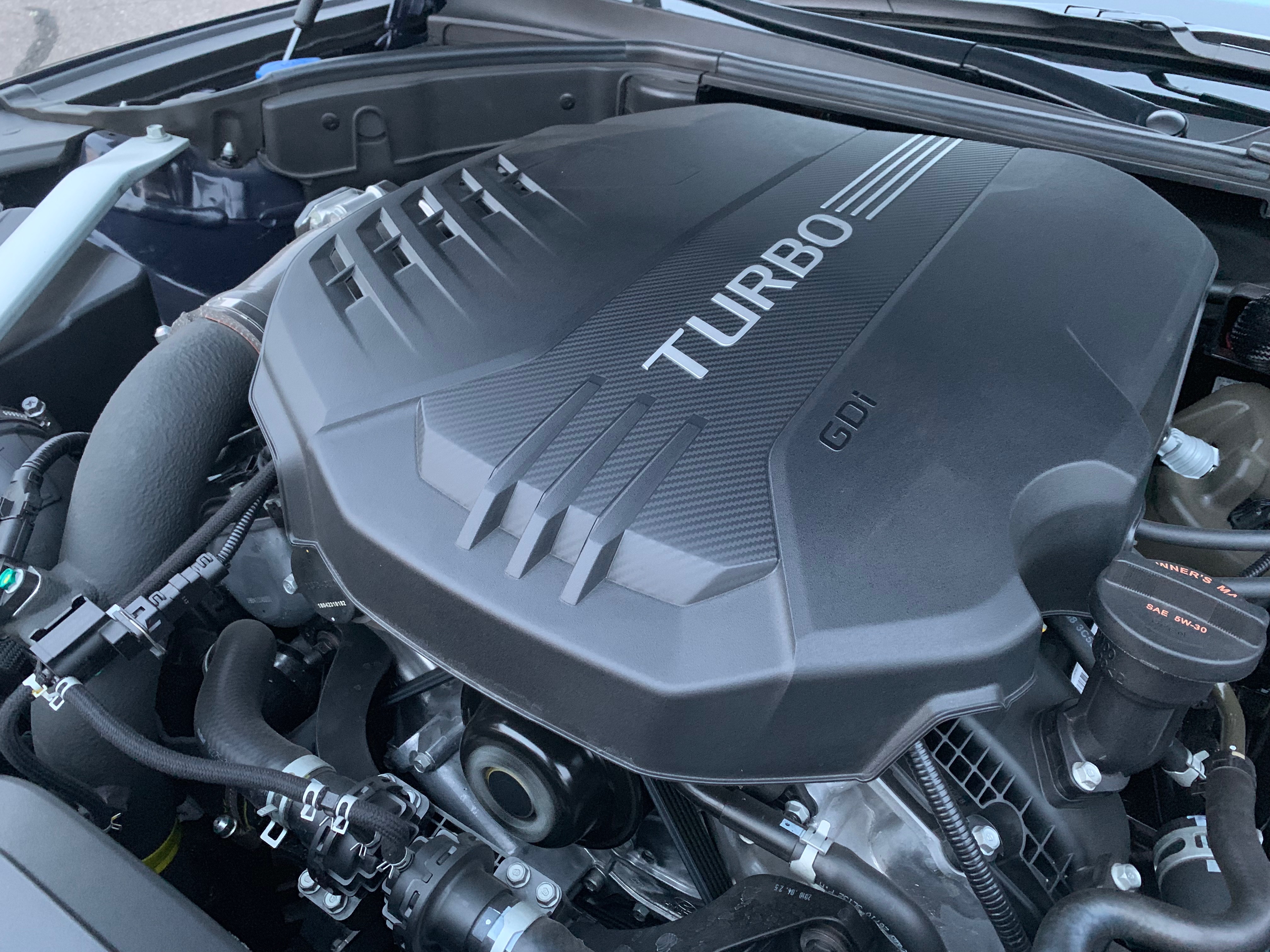 Raising the hood reveals the G70's optional 3.3-liter twin-turbo engine.