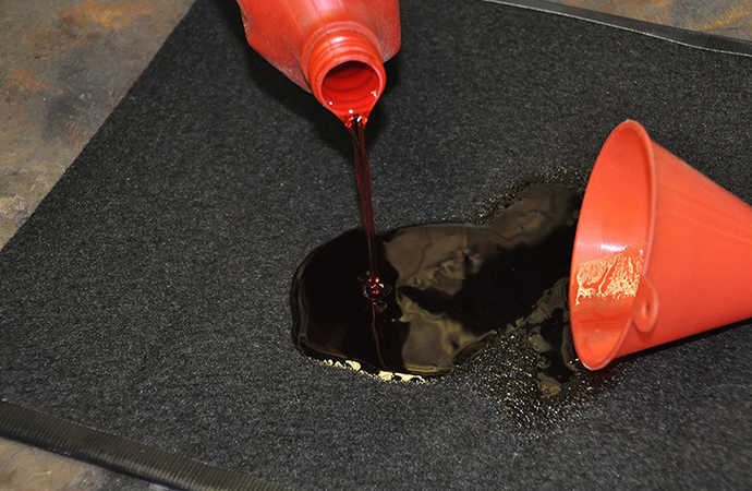 The new Oil Rug from Design Engineering Inc. is designed to help contain oil spills in the garage for easy cleanup. | Design Engineering Inc. photo