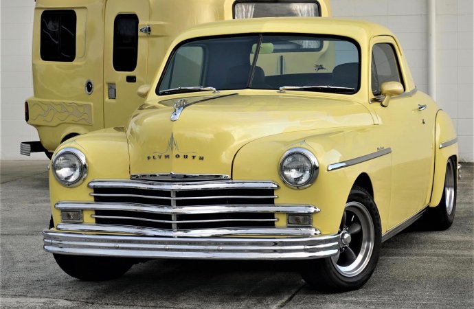 This ’49 Plymouth coupe pulls along a camp trailer